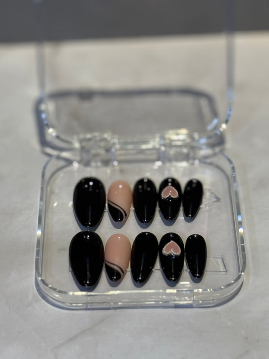 Dark black nails with elegant French tip detailing and a charming heart pendant accent. Perfect for creating a mysterious, sophisticated look with classic French manicure styling that delivers polished glamour. Ideal for expressing your unique personality and style with confidence.