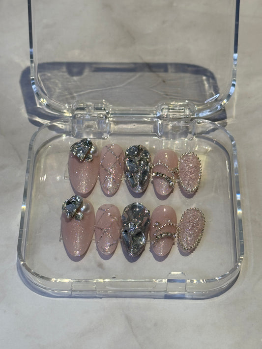 Immerse yourself in dreamy elegance with Kylies sweet dreams — medium almond press-on nails featuring soft, sophisticated styling. Each set showcases big handmade details , decorated with charms and shimmering rhinestones for a touch of luxury and individuality