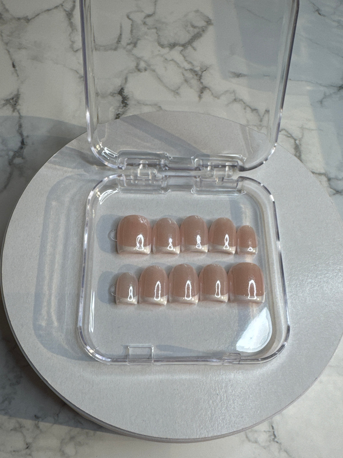 Luxury press-on nails, French manicure, shimmering light pink glitter.
