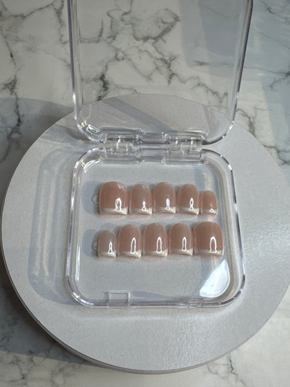 Luxury press-on nails, French manicure, shimmering light pink glitter.

