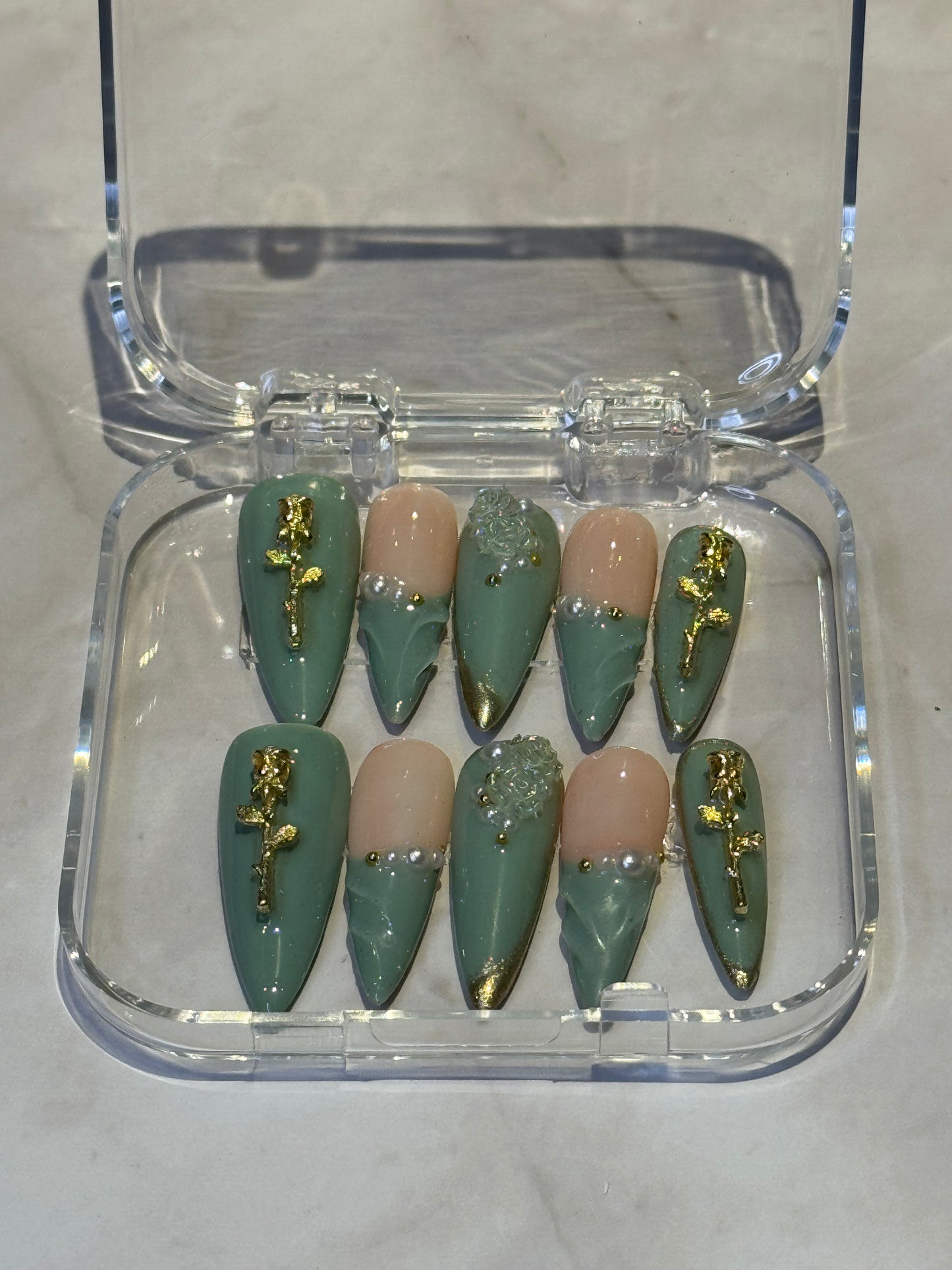 Green stilletto press on nails with gel effect,french tip , and rose charms.