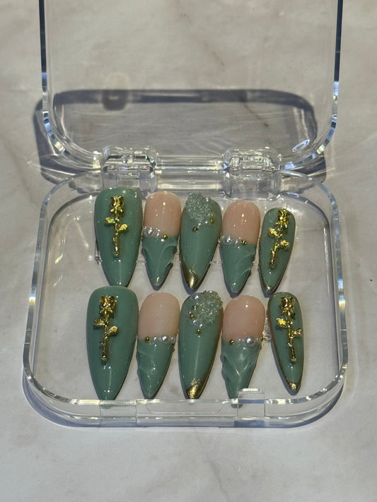 Green stilletto press on nails with gel effect,french tip , and rose charms.