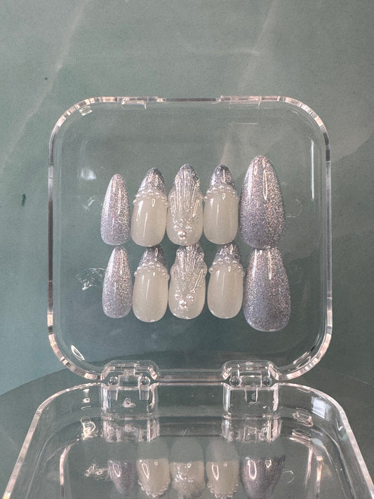 Almond medium long false nails featuring a stunning blue glitter cat-eye design with elegant gel decorations. Perfect for creating a sophisticated, eye-catching nail look that combines shimmer and dimension.
