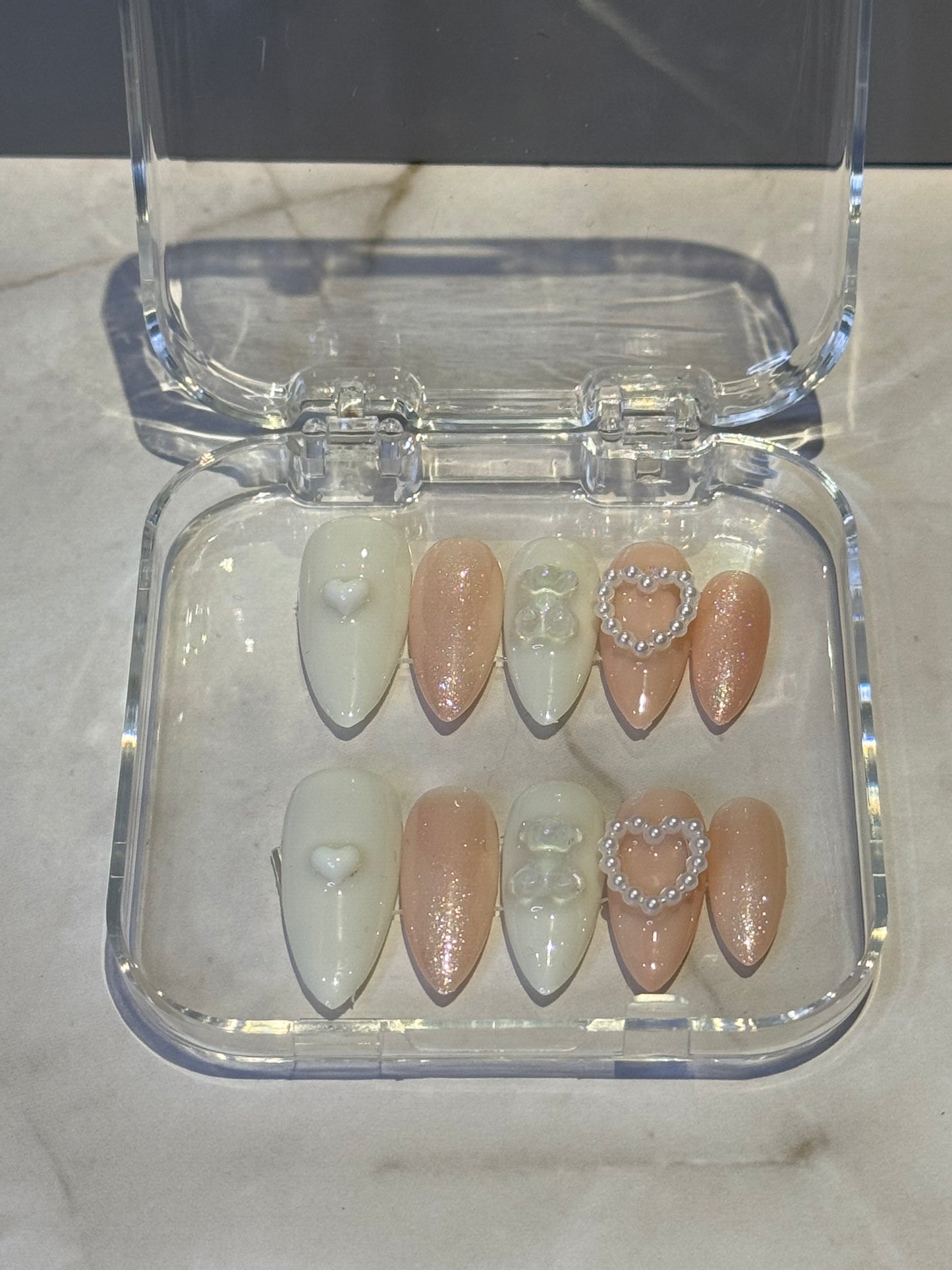white and nude shimmer colored press on nails with charms