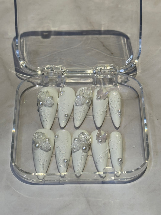 Stilletto nails in white , with pearl and cute charms . reuseable , fakenails