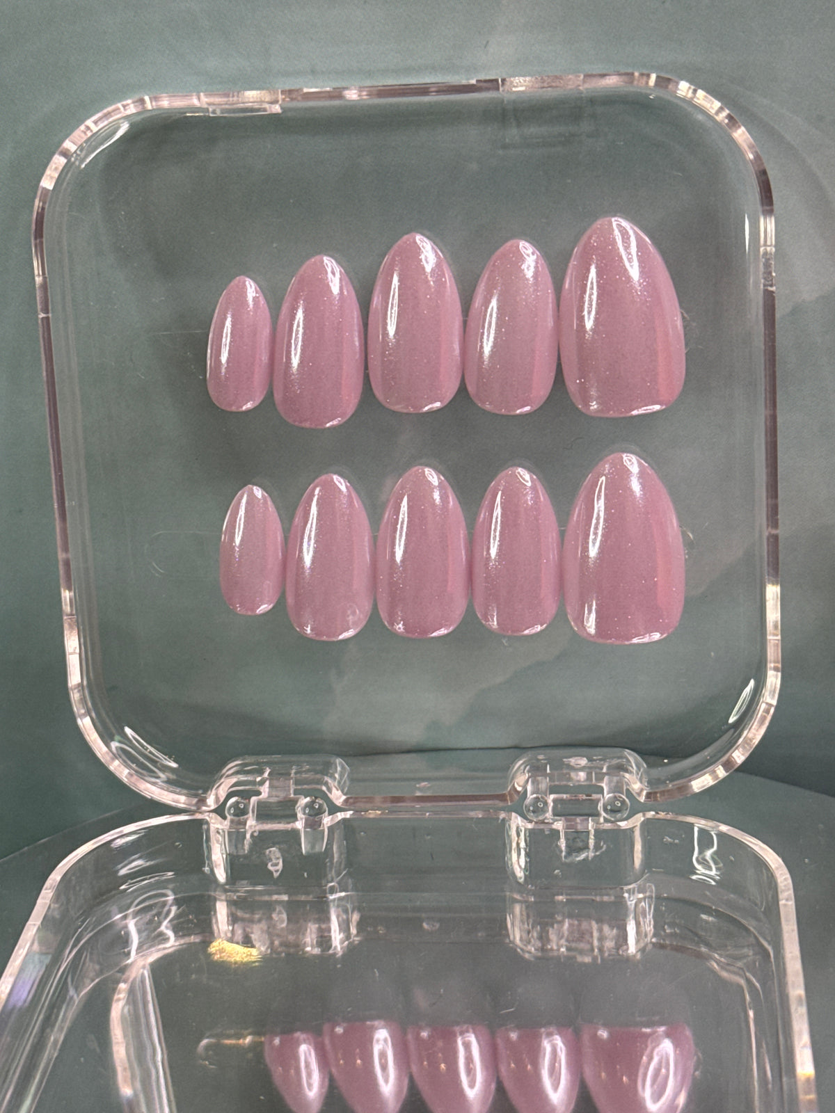 Short almond false nails in a stunning lavender shade with a reflective mirror finish. Each nail is hand-painted for a premium, dimensional look that catches the light beautifully. 