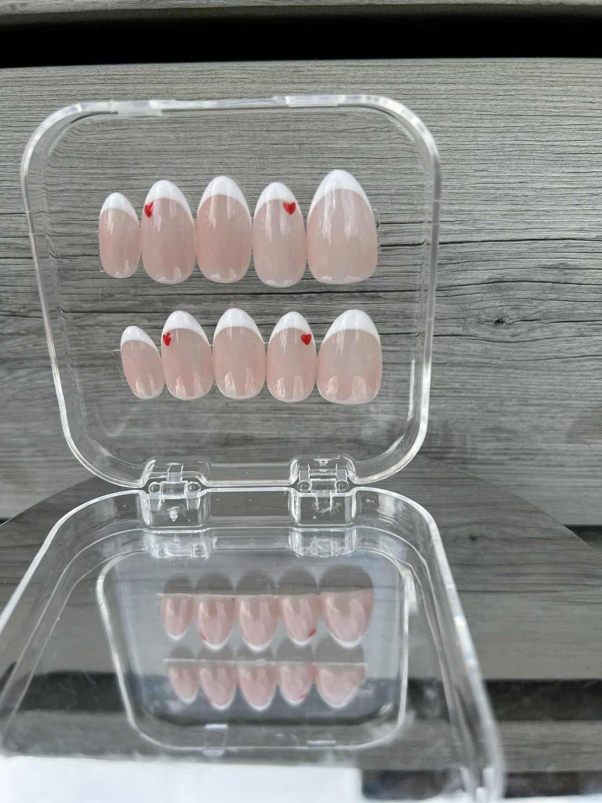 Handpainted heart and French tip nail art with gel quality finish. Premium design for a polished, sophisticated look that lasts
