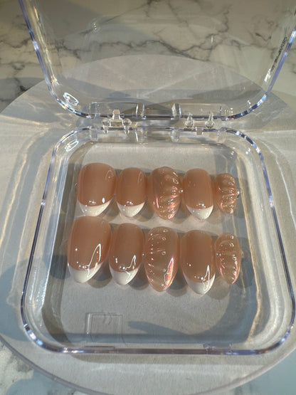 Luxury press-on nails, French manicure, light pink with 3D pattern, glossy.
