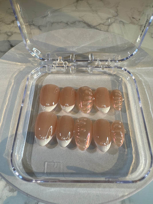 Luxury press-on nails, French manicure, light pink with 3D pattern, glossy.
