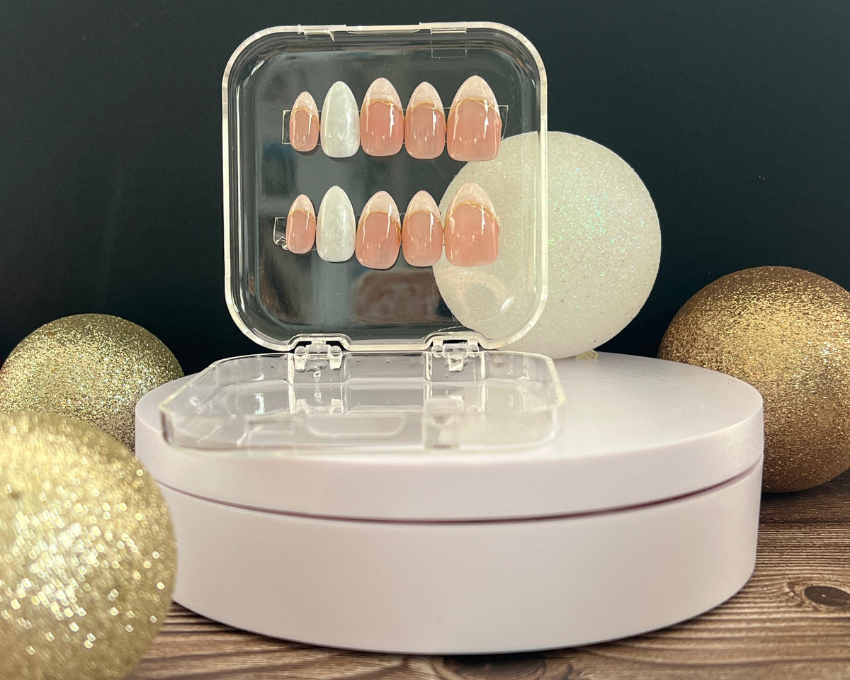 Luxury press-on nails, French manicure, pearlescent, light pink with gold details.
